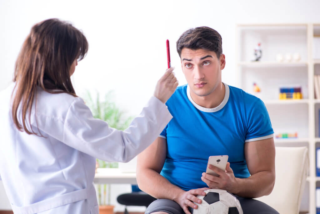 Football soccer player visiting doctor after injury